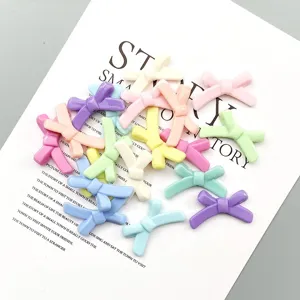 Colorful resin bowknot DIY beads detail shot, pastel charm accessories for bracelet making.