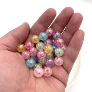 Close-up detail of colorful cracked acrylic round beads with AB coating for DIY jewelry making crafts.