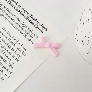 Pink bow loose bead for DIY bracelet jewelry making, cute craft accessory detail view.