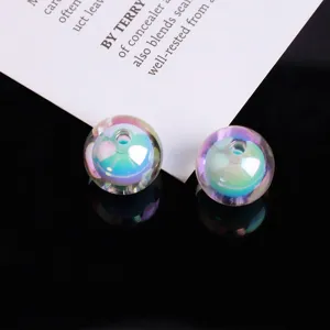 Close-up detail of iridescent AB color double sphere acrylic beads for DIY jewelry making.
