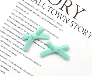 Mint green bow resin loose beads close up, perfect for DIY bracelet jewelry making and crafting.