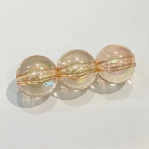 Close-up detail of translucent iridescent acrylic round beads with straight hole for DIY craft.