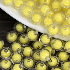 Acrylic bead-in-bead detail showing clear outer shell and yellow inner core for DIY crafts.