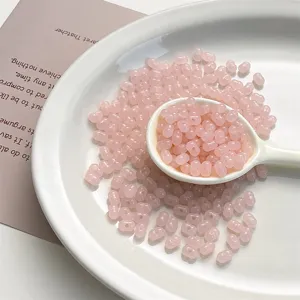 Acrylic peanut beads detail shot, pink translucent jelly beads for DIY jewelry making accessories.