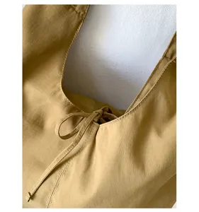 Detailed shot of a Korean style solid color slouchy shoulder tote bag with a bow detail.
