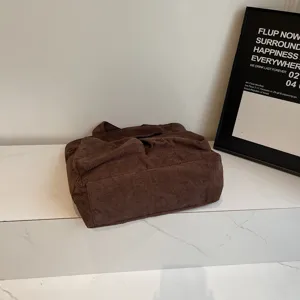 Corduroy tote bag detail, brown shoulder handbag for casual daily commute and student use.