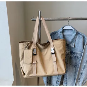Large capacity khaki canvas tote bag with shoulder straps, plastic buckles and a small hanging pouch.
