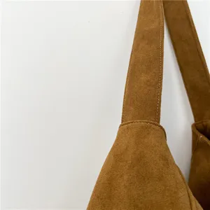 Brown suede shoulder bag strap detail, soft texture and durable stitching for daily commute.