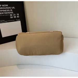 Bottom detail view of large capacity khaki travel duffel bag with durable strap design.