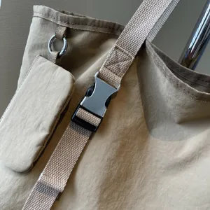 Detail view of large capacity casual canvas tote shoulder bag with durable metal buckle.