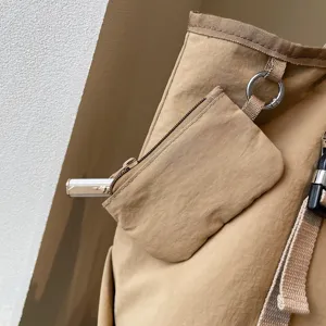 Detailed view of large capacity casual tote bag with mini pouch, durable canvas and metal hardware.