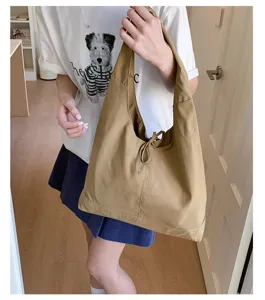 Casual slouchy canvas shoulder bag with bow detail, large capacity tote for women daily wear.