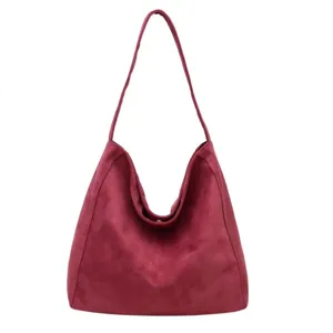 Detailed view of the vintage burgundy suede shoulder bag, showing soft texture and roomy shape.