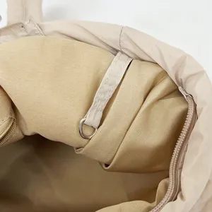 Beige nylon tote bag interior detail, soft puffer design, versatile daily use handbag.