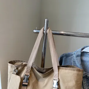 Large capacity casual tote bag, versatile shoulder travel bag with durable straps and buckles.