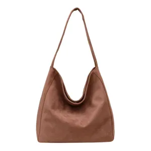 Brown suede slouchy shoulder bag detail, soft minimalist hobo handbag for daily use.