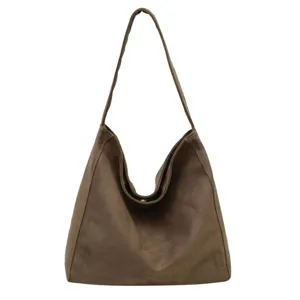 Detailed view of the brown suede shoulder bag, soft slouchy hobo texture and stitching.