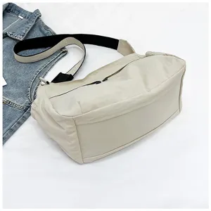 Nylon crossbody bag detail, casual workwear style shoulder bag, spacious daily commuter design.