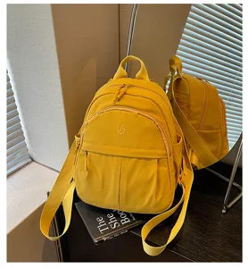 Detailed view of yellow nylon mini backpack, simple, casual and versatile for daily commuting.