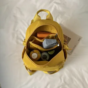 Yellow nylon small backpack, casual minimalist daypack for women, daily commuter school bag.