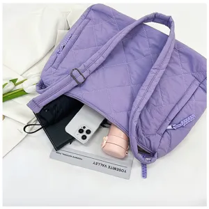 Detailed top-down view of purple quilted nylon tote bag showing spacious capacity and storage.