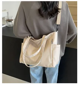 Detailed view of the beige waterproof nylon tote bag showing large capacity and side pocket.