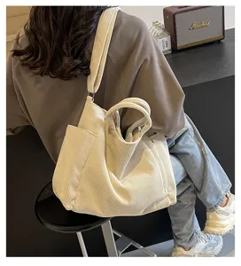 Detailed view of large capacity beige corduroy tote bag, casual shoulder and crossbody use.