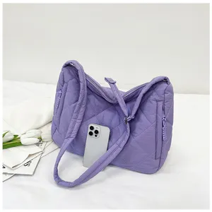Detailed view of the purple quilted nylon tote bag with puffer design and spacious shoulder strap.