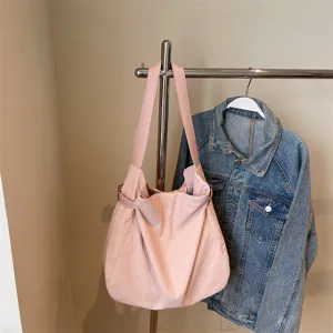 Pink nylon shoulder tote bag detail view, casual lightweight commuter handbag style.