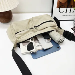Nylon crossbody bag detail view showing large capacity and multi-pocket daily storage organization.