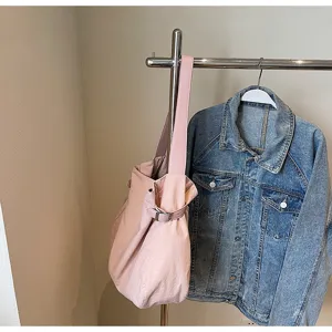 Pink slouchy shoulder tote bag detail showcasing soft material, buckle strap, and clean daily commuting style.
