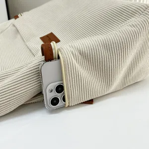 Beige corduroy tote bag detail shot, large capacity shoulder handbag for daily student use.