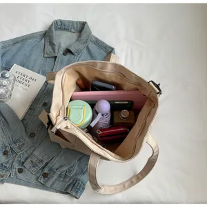 Detail view of the large capacity nylon tote bag showing interior space and daily items.
