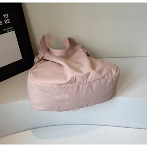 Minimalist lightweight nylon shoulder bag detail view, stylish pink tote for daily commute.