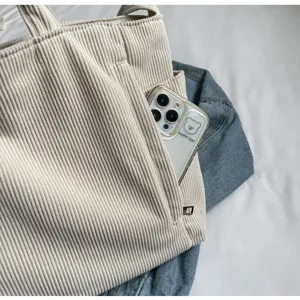Beige corduroy tote bag detail view showing large capacity, dual handles and side pocket.