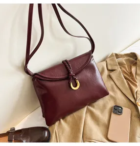 Dark red vegetable-tanned leather shoulder bag, soft envelope crossbody bag with metal buckle.