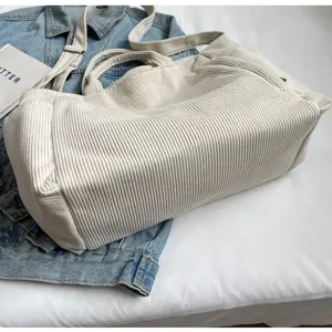 Large capacity corduroy tote bag for women, casual single shoulder and crossbody commuting bag.
