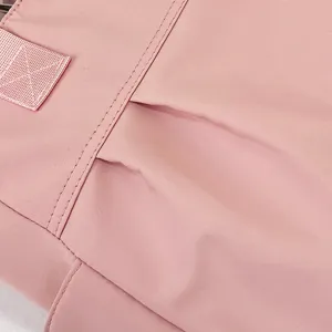 Close-up detail of pink nylon tote bag showing precise stitching and durable fabric texture.
