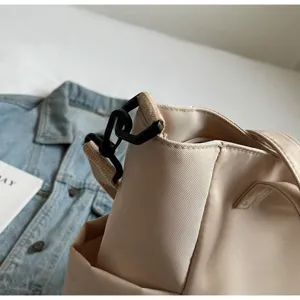 Waterproof nylon tote bag detail showing shoulder strap buckle and durable fabric.