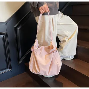 Minimalist lightweight nylon shoulder bag for women, casual tote handbag for commute.