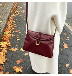 Niche design leather shoulder bag, soft envelope crossbody bag with braided knot and gold ring.