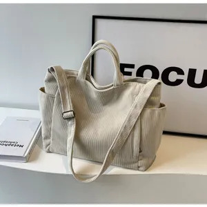 Large capacity corduroy tote bag for women, casual shoulder handbag with crossbody strap and pockets.