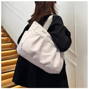 Detail view of a large-capacity nylon tote bag for women, simple commuting shoulder bag style.
