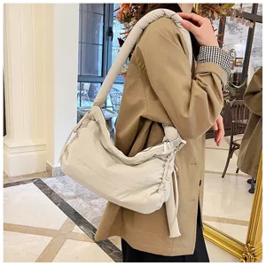 Padded shoulder bag with knots and drawstrings, soft commuter crossbody tote in solid off-white.