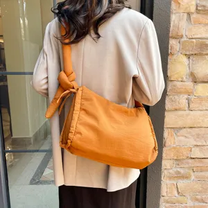 Padded single shoulder crossbody bag with unique knot design, large capacity casual tote.