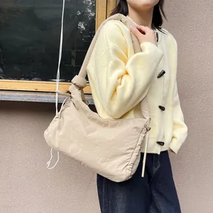 Padded shoulder bag for women, casual crossbody tote with knot and drawstring design.