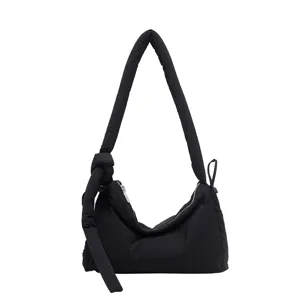Solid black padded shoulder bag with knotted strap, large capacity soft commuting tote.