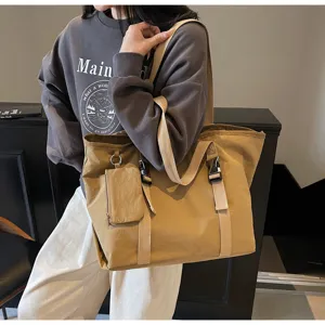 Large canvas tote shoulder bag with exterior pocket and buckle details for daily travel