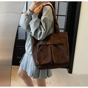 Detailed view of brown corduroy tote bag, large capacity shoulder bag for daily commute.