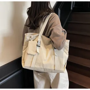 Large capacity beige canvas tote bag with small pouch and buckle straps for women travel.